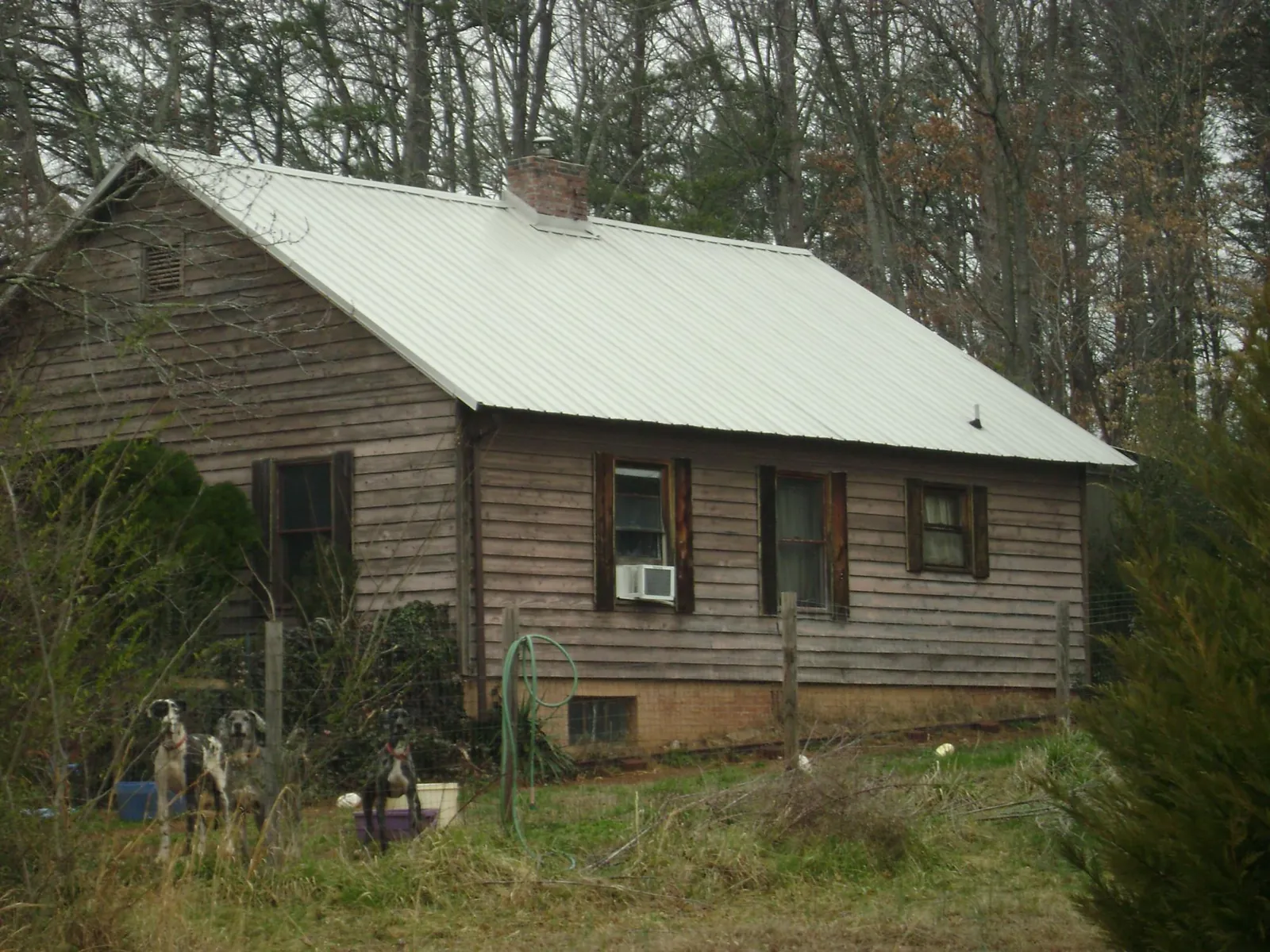 White metal roof on an old wood sided farmhouse, from a Metal Roof Installation job in New Lisbon